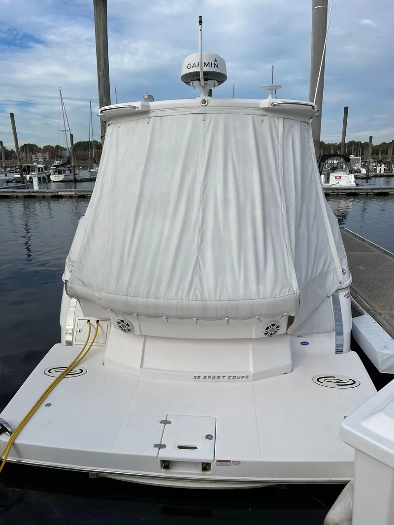 Slide: The Image of 2021 Regal 35 Sport Coupe docked at marina, rear view with cover. - 14