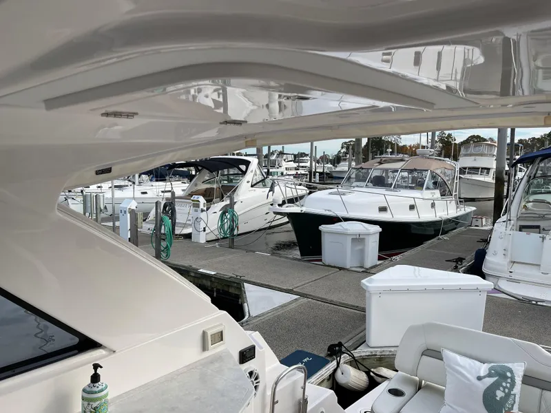 Slide: The Image of 2021 Regal 35 Sport Coupe docked at marina with other boats in view. - 17