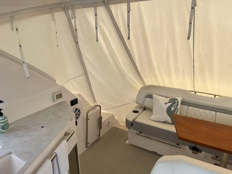 Slide: The Image of 2021 Regal 35 Sport Coupe interior with seating, table, and kitchenette. - 20