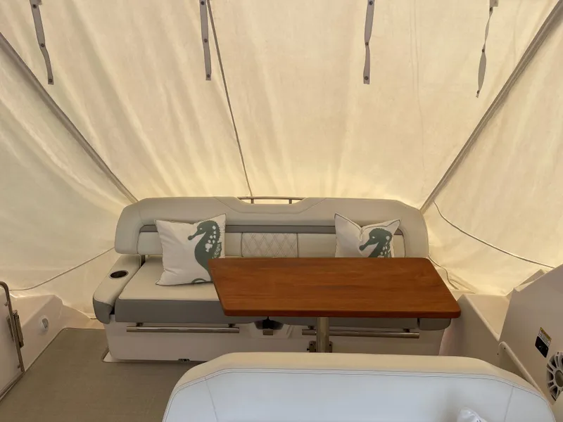 Slide: The Image of Interior of 2021 Regal 35 Sport Coupe with seating and wooden table. - 21