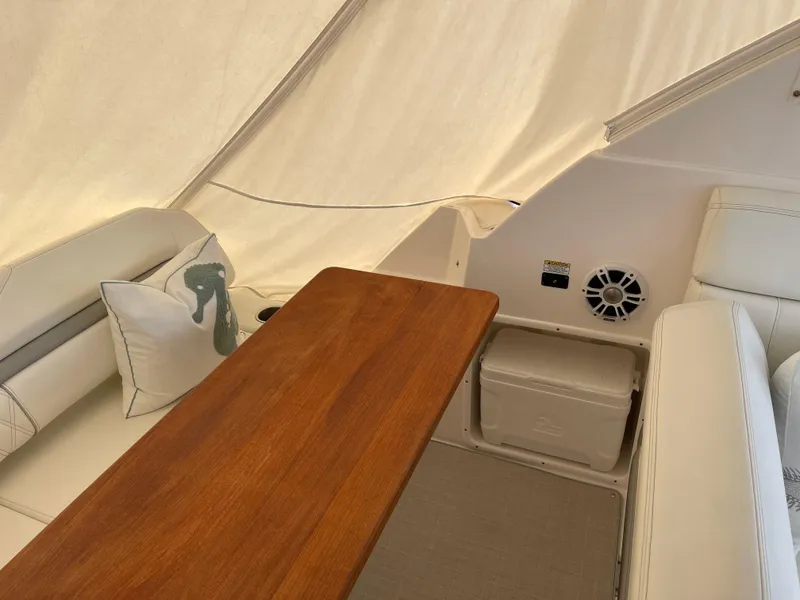 Slide: The Image of Interior of 2021 Regal 35 Sport Coupe with wooden table and white seating. - 23