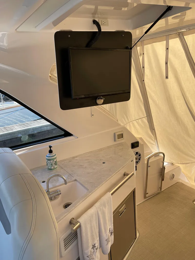 Slide: The Image of Interior of 2021 Regal 35 Sport Coupe with TV, sink, and countertop. - 26