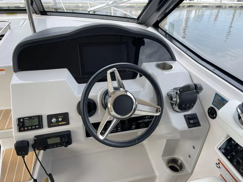 Slide: The Image of 2021 Regal 35 Sport Coupe helm with steering wheel and control panel. - 29