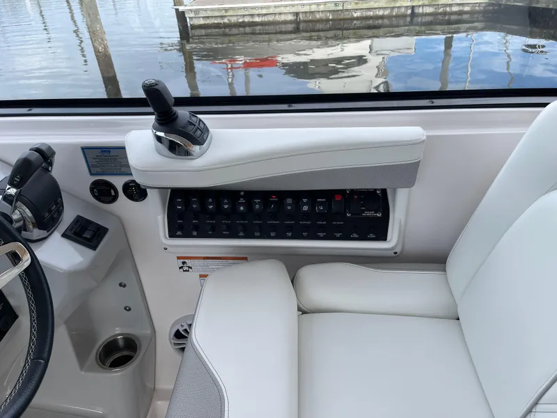 Slide: The Image of 2021 Regal 35 Sport Coupe helm with joystick control and switch panel. - 32