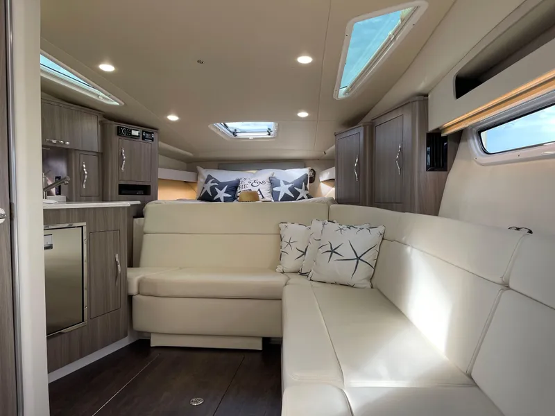 Slide: The Image of Interior of 2021 Regal 35 Sport Coupe with modern seating and skylights. - 38