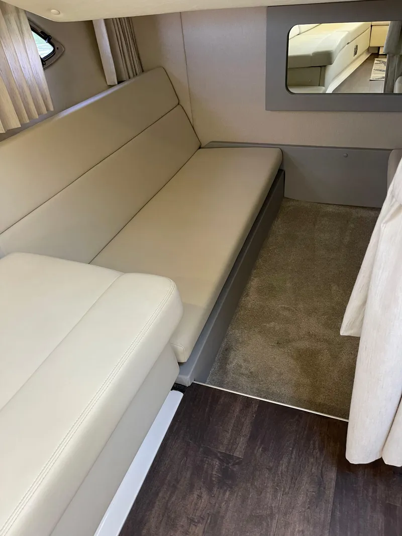 Slide: The Image of 2021 Regal 35 Sport Coupe interior with beige seating and carpeted flooring. - 40