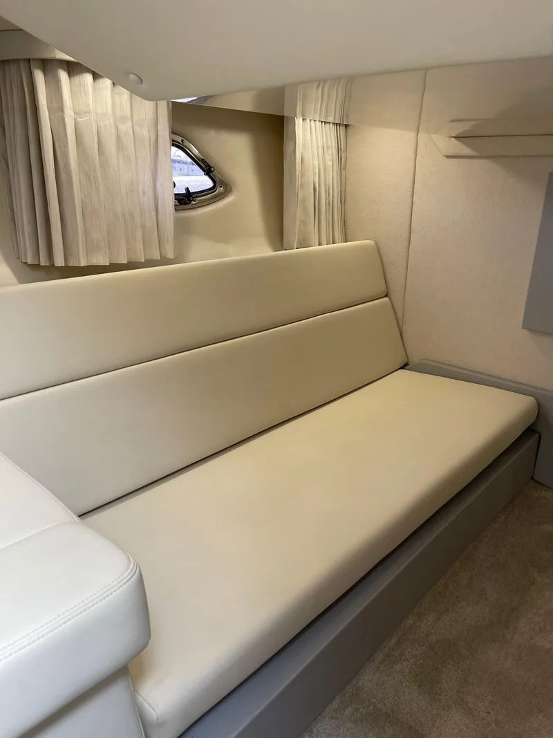 Slide: The Image of 2021 Regal 35 Sport Coupe interior with beige seating and curtains. - 42