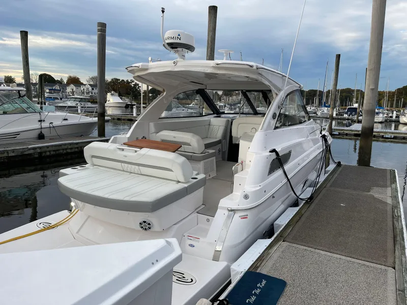 Slide: The Image of 2021 Regal 35 Sport Coupe docked at a marina, showcasing sleek design and spacious interior. - 5