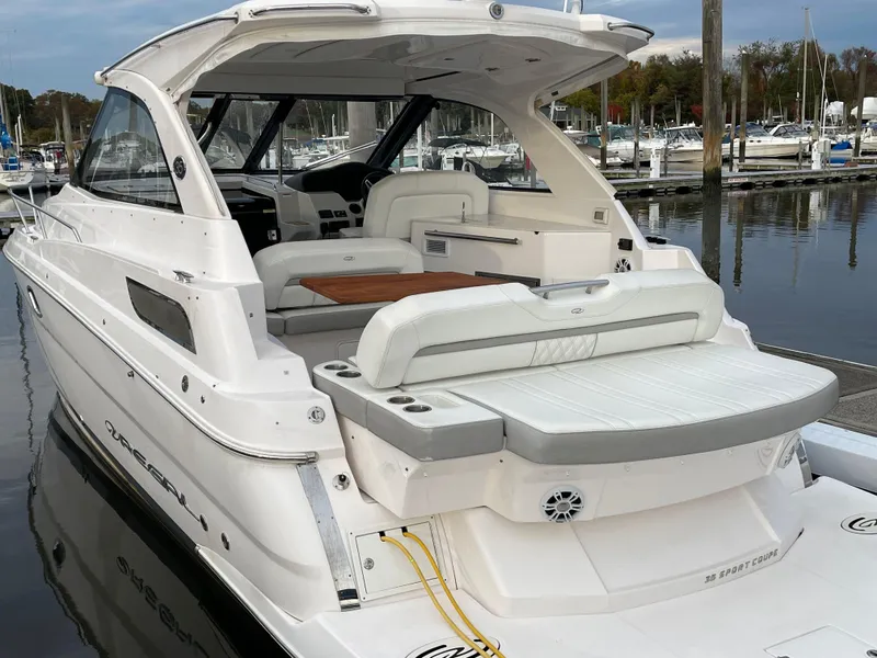 Slide: The Image of 2021 Regal 35 Sport Coupe boat docked at marina, featuring spacious seating and sleek design. - 6