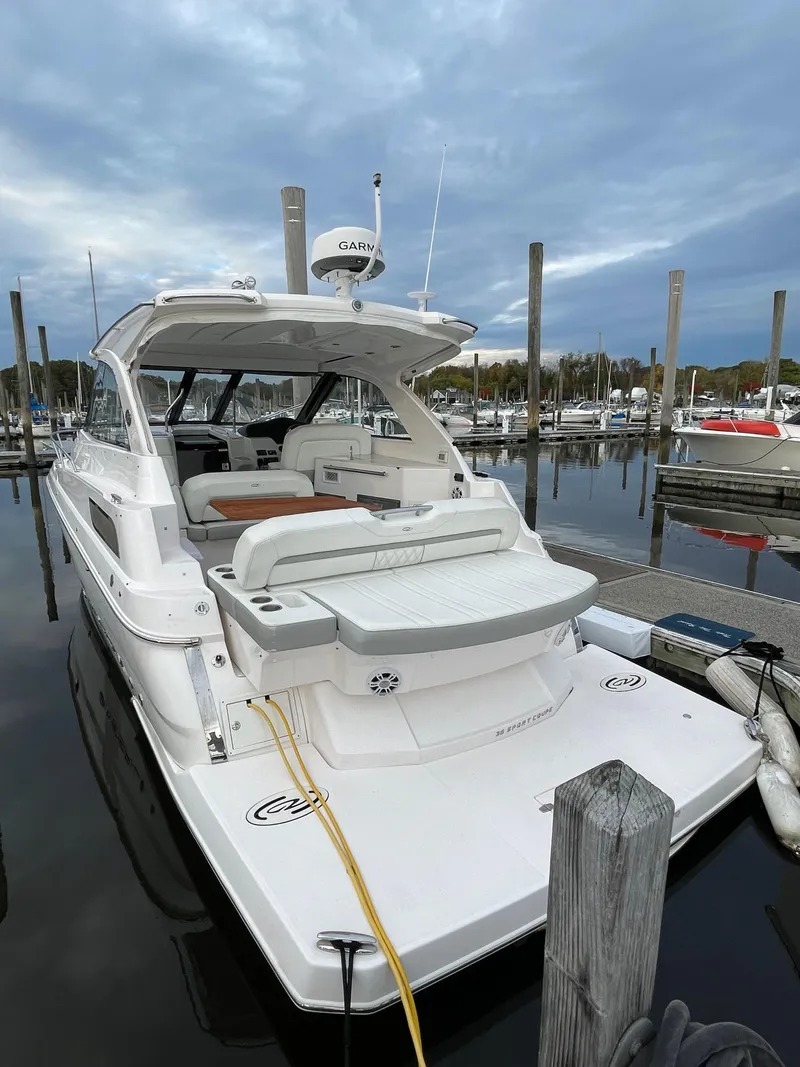 Slide: The Image of 2021 Regal 35 Sport Coupe docked at marina under cloudy sky. - 8