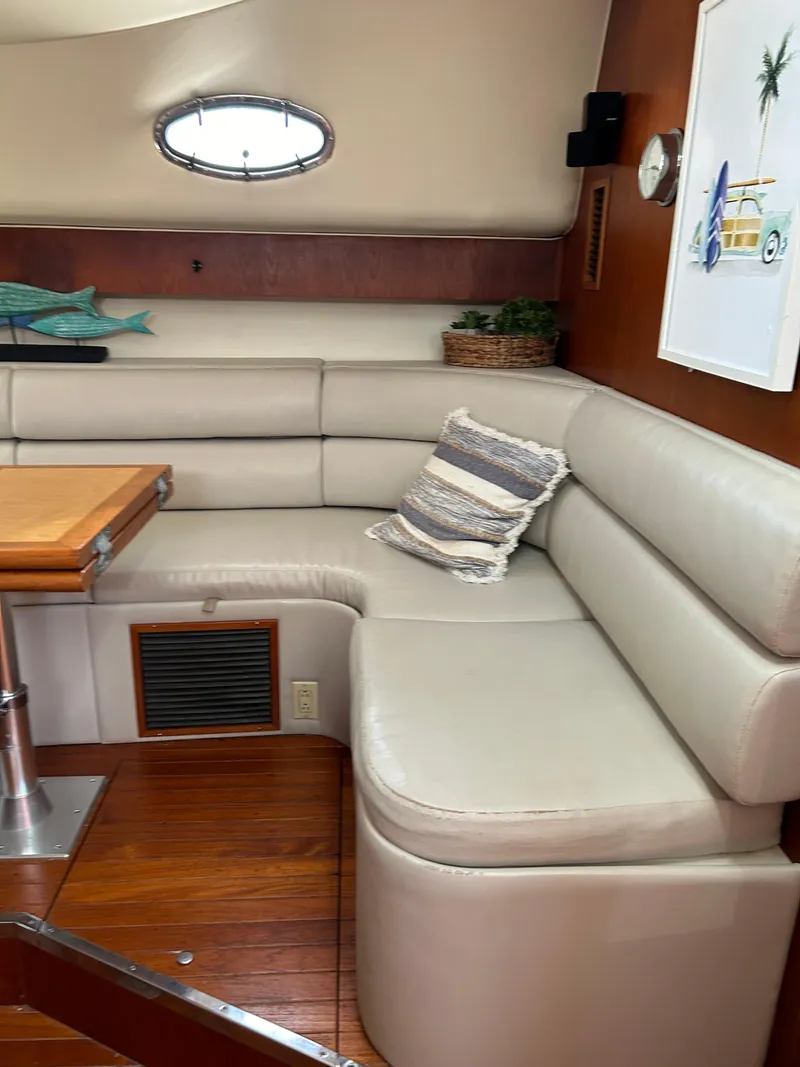 Slide: The Image of Interior of 1997 Tiara Yachts 4000 Express with beige seating and wooden accents. - 13