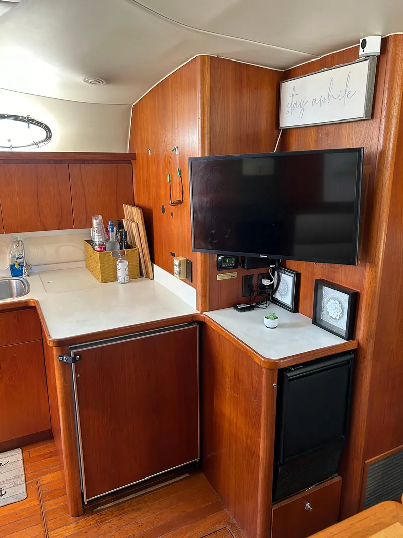Slide: The Image of 1997 Tiara Yachts 4000 Express interior with wood cabinetry and mounted TV. - 17