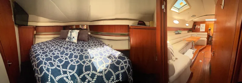 Slide: The Image of Interior of 1997 Tiara Yachts 4000 Express, featuring a cozy bedroom and elegant living area. - 20