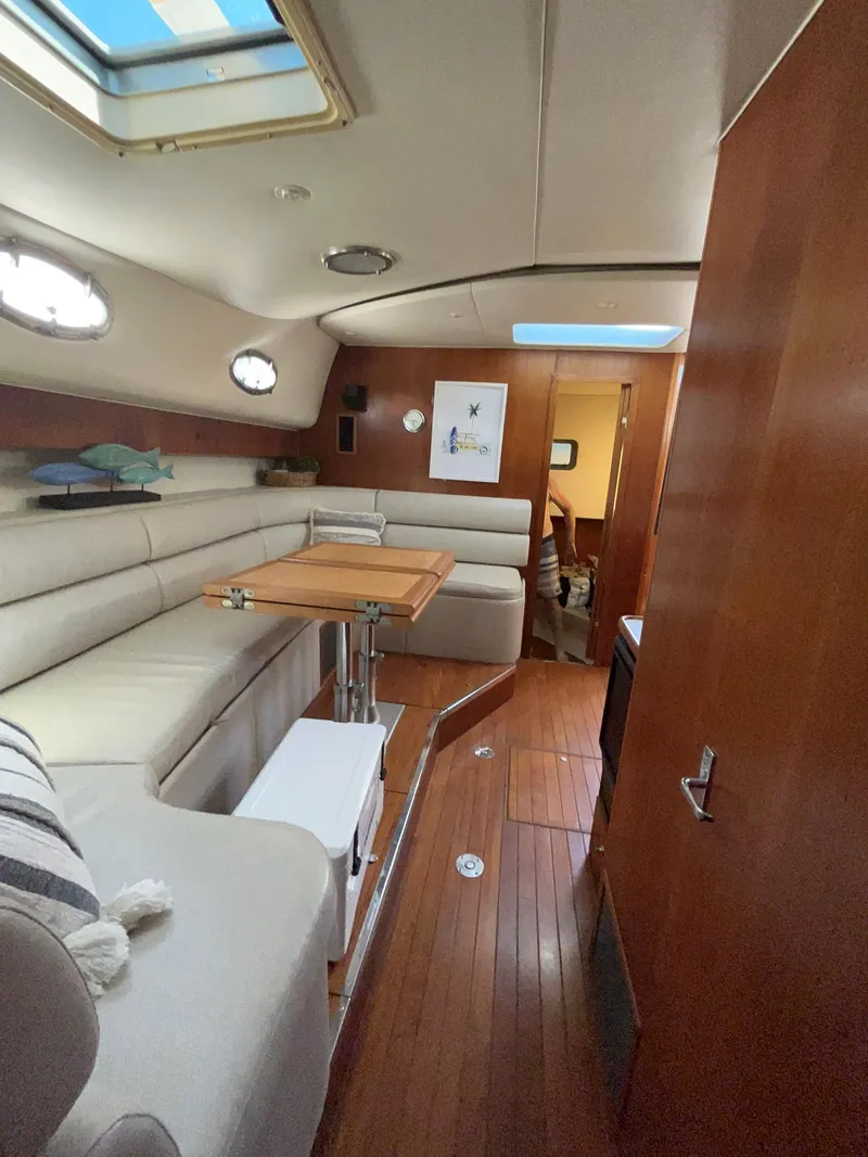 Slide: The Image of Interior of 1997 Tiara Yachts 4000 Express with elegant seating and wooden flooring. - 21