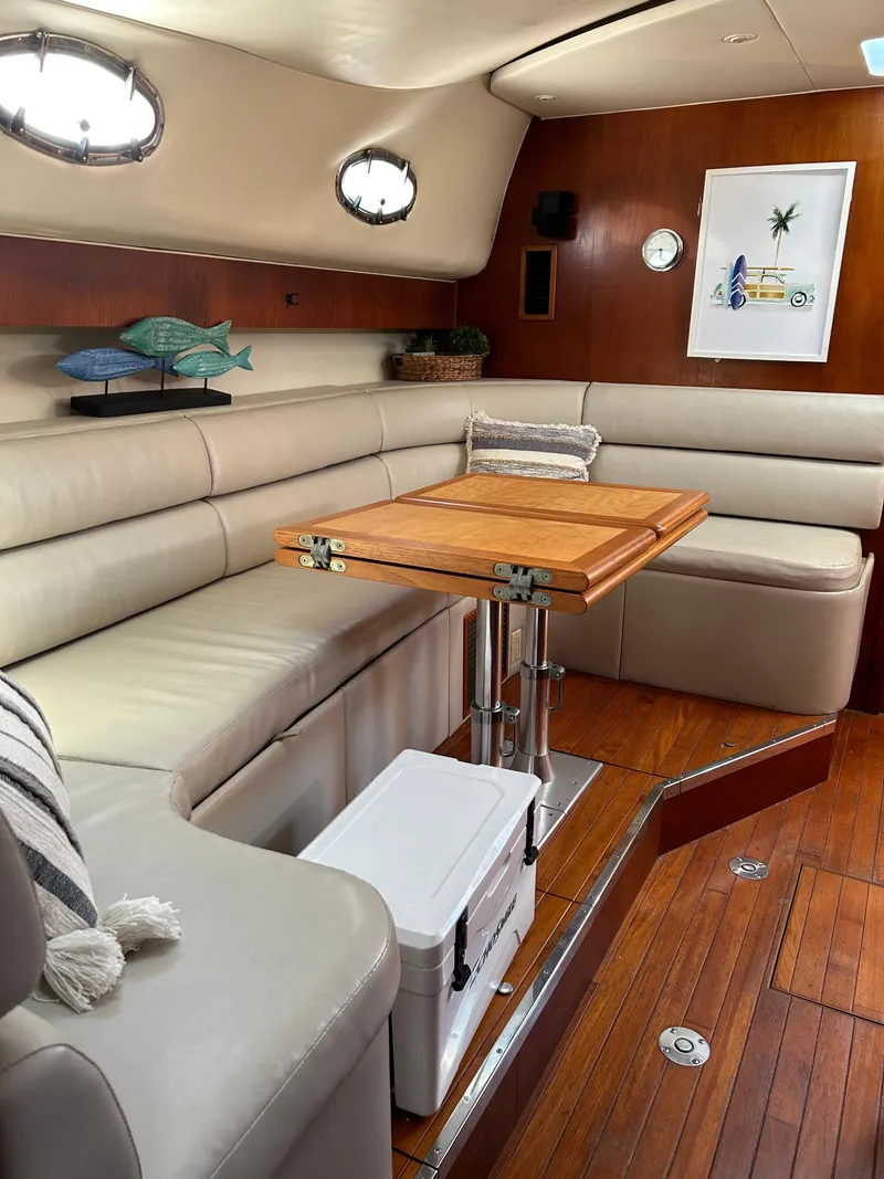 Slide: The Image of Interior of 1997 Tiara Yachts 4000 Express with elegant seating and wooden table. - 22