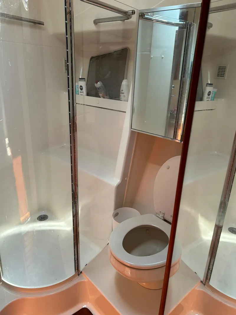 Slide: The Image of Bathroom interior of 1997 Tiara Yachts 4000 Express, featuring shower and toilet. - 24