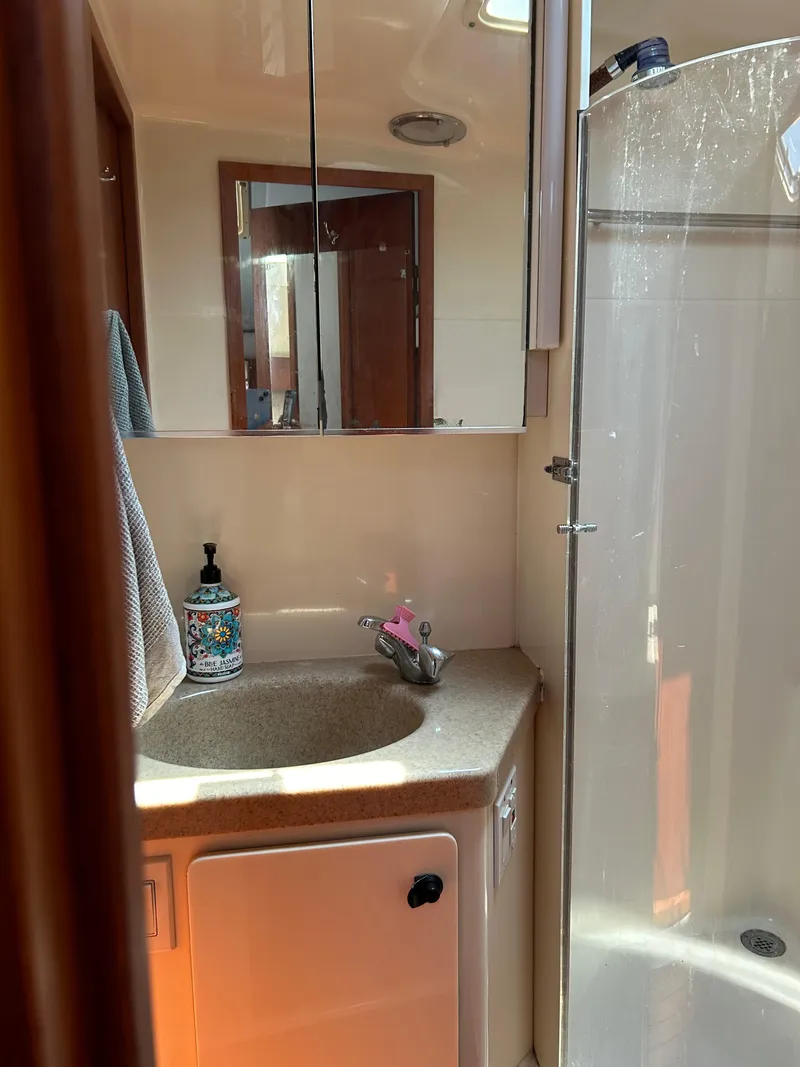 Slide: The Image of 1997 Tiara Yachts 4000 Express bathroom with sink, mirror, and shower. - 25