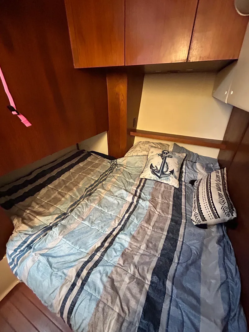 Slide: The Image of Cozy cabin interior of 1997 Tiara Yachts 4000 Express with nautical-themed bedding. - 27