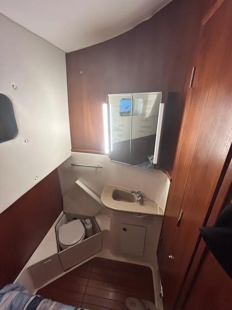 Slide: The Image of 1997 Tiara Yachts 4000 Express bathroom with sink, mirror, and toilet. - 29