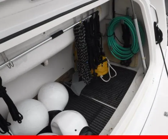 Slide: The Image of Storage compartment of 1997 Tiara Yachts 4000 Express with ropes and fenders. - 32