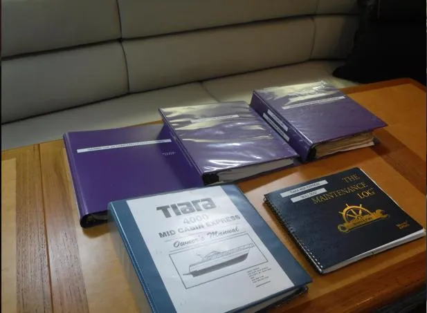 Slide: The Image of Manuals and maintenance logs for 1997 Tiara Yachts 4000 Express on a table. - 33