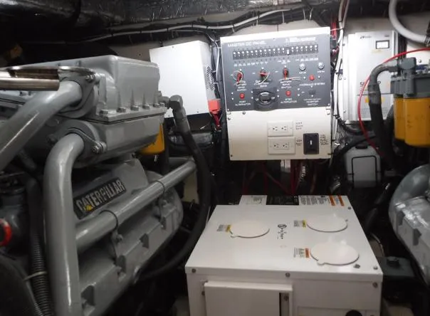 Slide: The Image of Engine room of 1997 Tiara Yachts 4000 Express, featuring Caterpillar engine and control panel. - 35