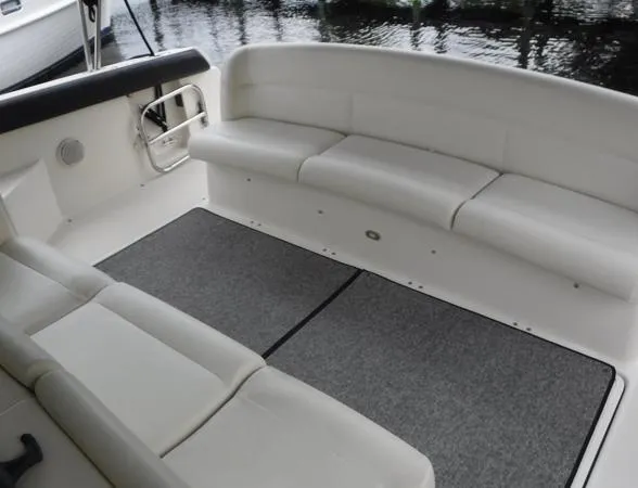 Slide: The Image of 1997 Tiara Yachts 4000 Express interior with white seating and gray carpet. - 7