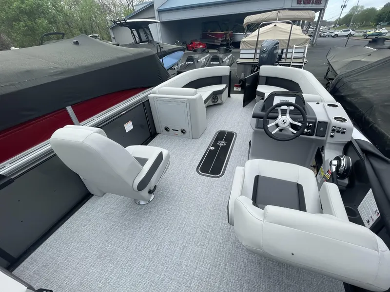 Slide: The Image of 2025 Harris Cruiser 230 boat interior with modern seating and steering console. - 14