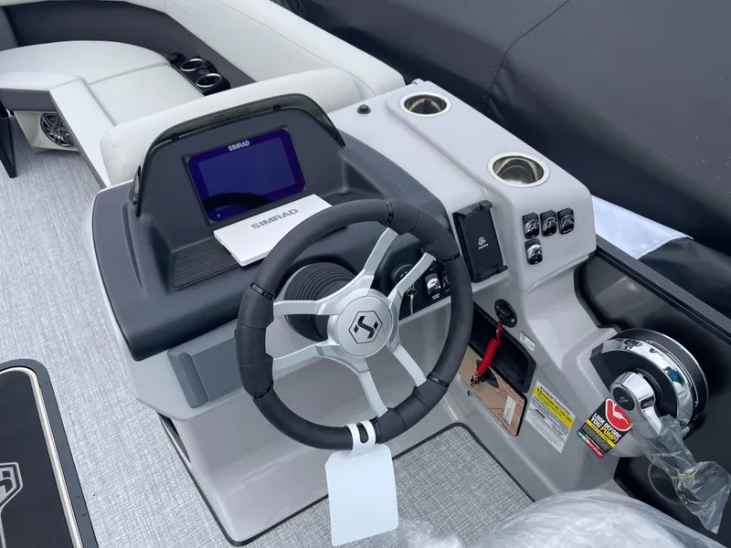 Slide: The Image of 2025 Harris Cruiser 230 boat dashboard with steering wheel and control panel. - 5