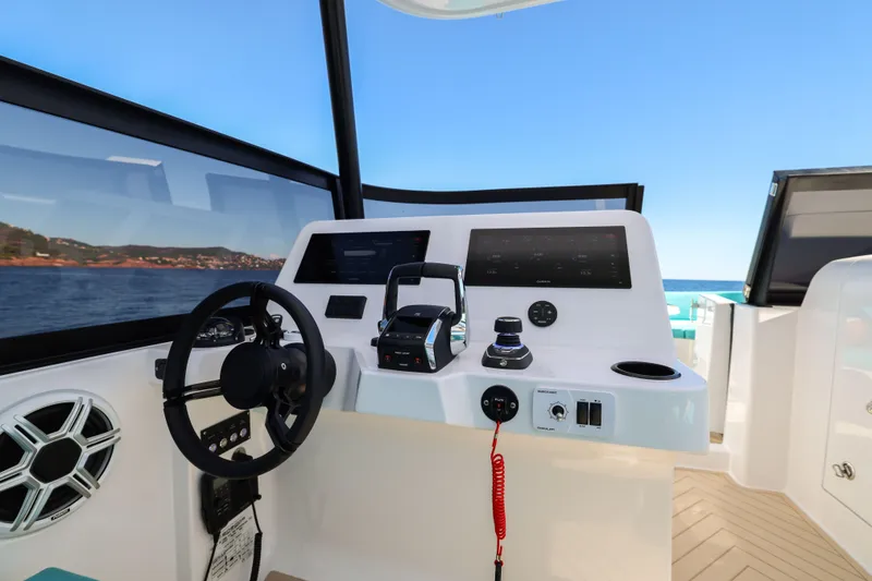 Slide: The Image of Helm of 2025 Canados Heritage 36 yacht with modern controls and ocean view. - 17