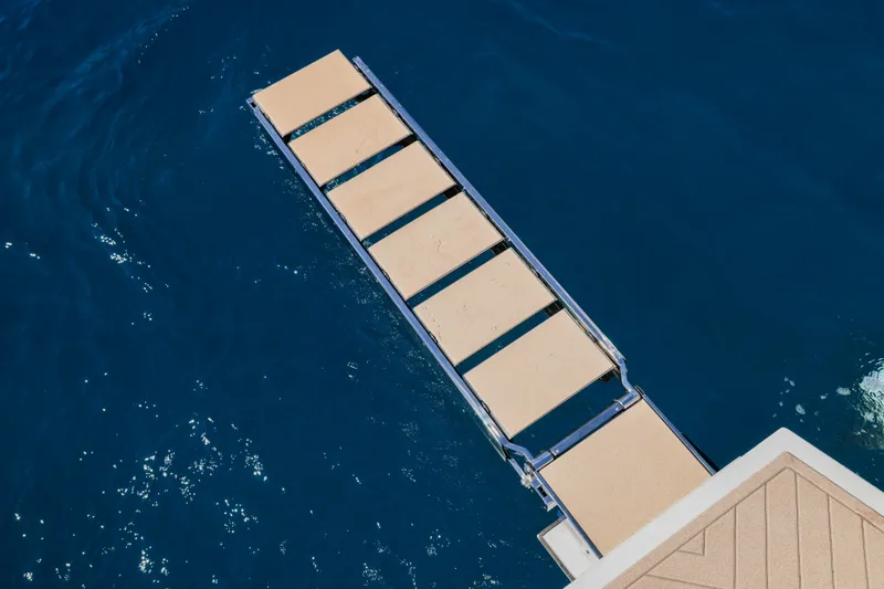 Slide: The Image of Retractable gangway of 2025 Canados Heritage 36 yacht over blue water. - 19