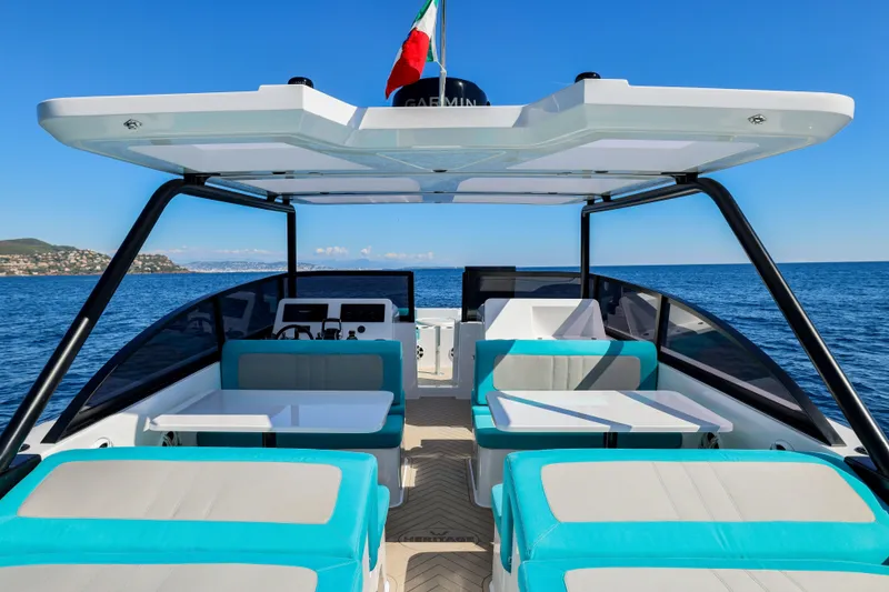 Slide: The Image of 2025 Canados Heritage 36 yacht interior with turquoise seating, open sea view. - 21