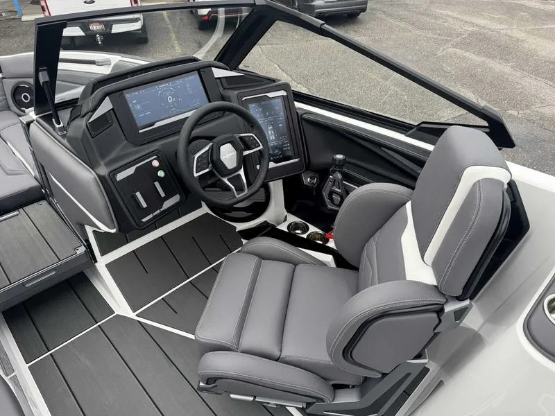 Slide: The Image of 2025 Supra SL boat cockpit with modern steering, digital displays, and comfortable seating. - 11