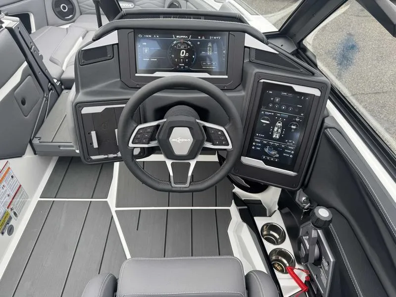 Slide: The Image of 2025 Supra SL boat dashboard with advanced digital displays and modern steering wheel design. - 12