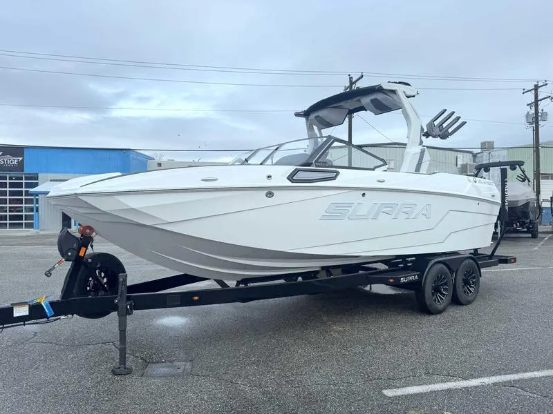 Slide: The Image of 2025 Supra SL boat on trailer in parking lot, showcasing sleek design and modern features. - 3