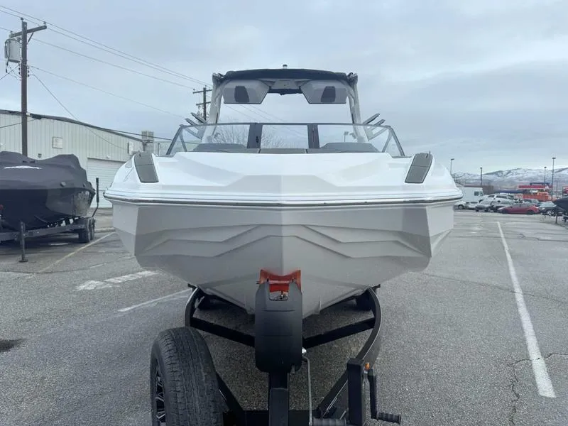 Slide: The Image of 2025 Supra SL boat on trailer, front view, parked outdoors. - 4