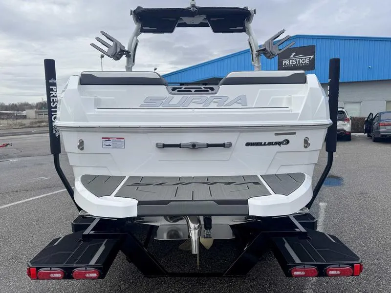 Slide: The Image of 2025 Supra SL boat rear view, featuring swim platform and wakeboard tower. - 7