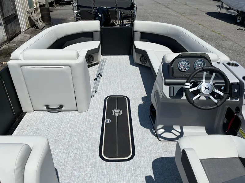 Slide: The Image of 2025 Harris Cruiser 230 boat interior with sleek seating and modern dashboard. - 10