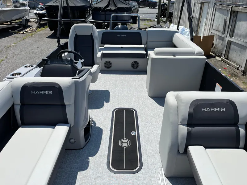Slide: The Image of 2025 Harris Cruiser 230 pontoon boat interior with gray seating and steering console. - 8