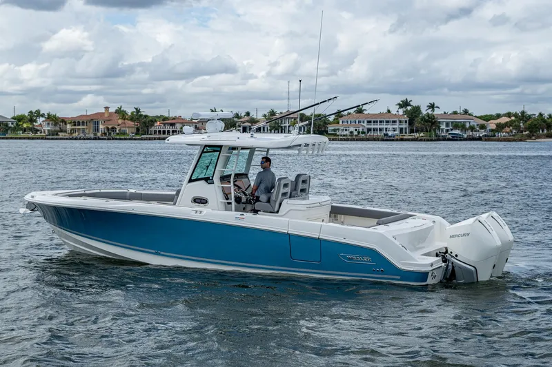 Slide: The Image of 2023 Boston Whaler 330 Outrage boat cruising on a calm waterway. - 16