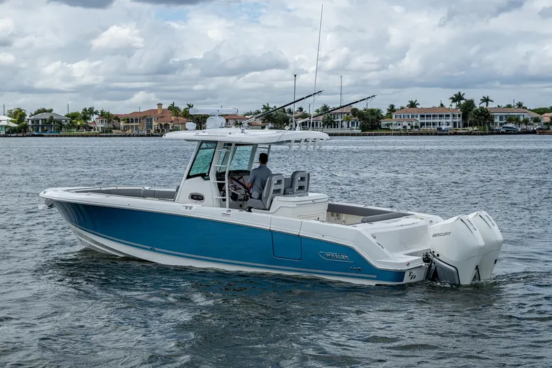 Slide: The Image of 2023 Boston Whaler 330 Outrage boat cruising on a calm waterway. - 17