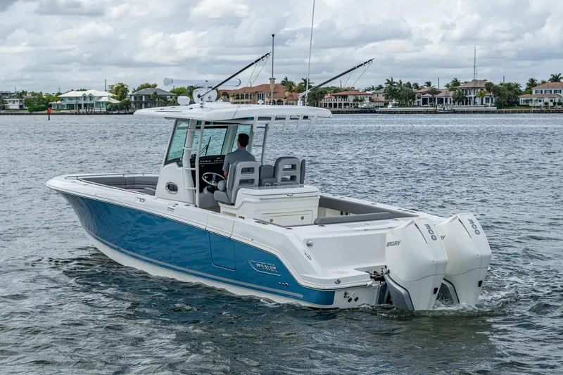 Slide: The Image of 2023 Boston Whaler 330 Outrage boat cruising on a calm waterway. - 18