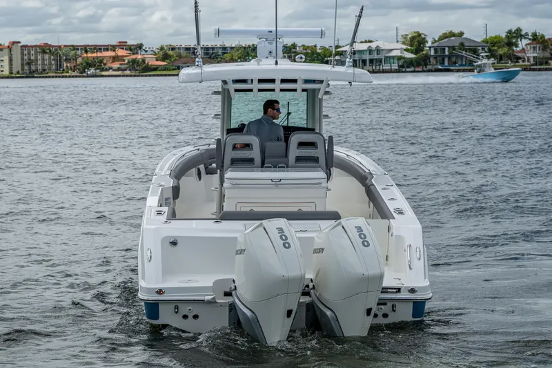Slide: The Image of 2023 Boston Whaler 330 Outrage boat with dual engines on water. - 19