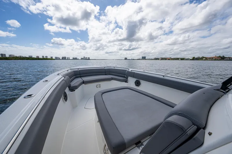 Slide: The Image of 2023 Boston Whaler 330 Outrage boat on open water under a cloudy sky. - 23