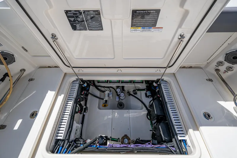 Slide: The Image of 2023 Boston Whaler 330 Outrage engine compartment, showcasing internal components and wiring. - 32