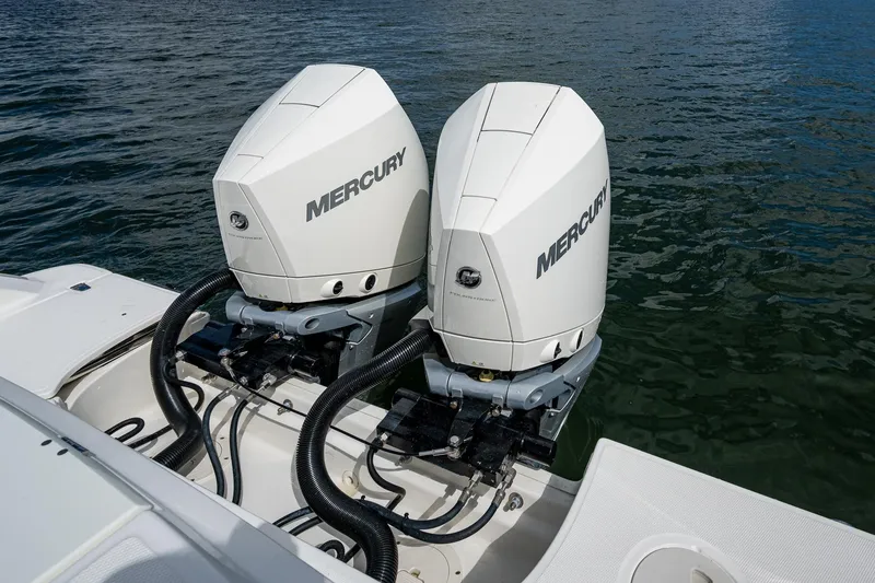 Slide: The Image of 2023 Boston Whaler 330 Outrage with dual Mercury outboard engines on water. - 43
