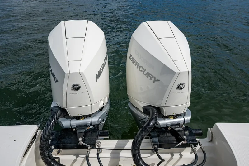 Slide: The Image of Twin Mercury outboard engines on a 2023 Boston Whaler 330 Outrage boat. - 44