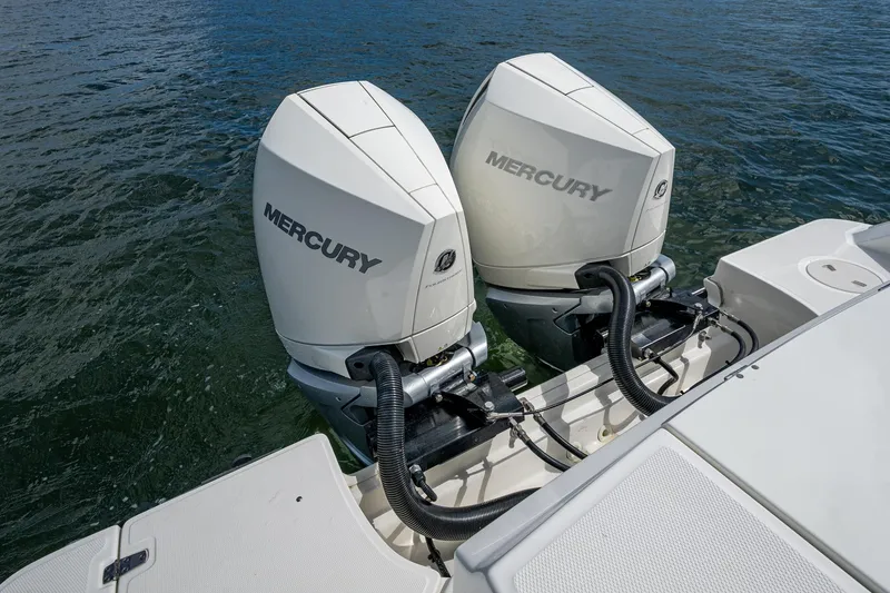 Slide: The Image of 2023 Boston Whaler 330 Outrage with dual Mercury outboard engines on water. - 45