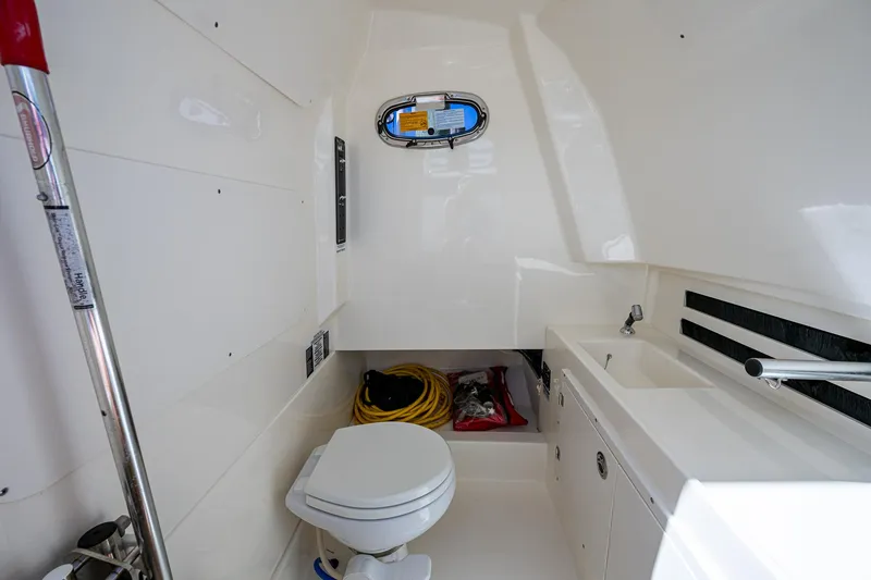 Slide: The Image of 2023 Boston Whaler 330 Outrage interior with toilet and sink. - 47