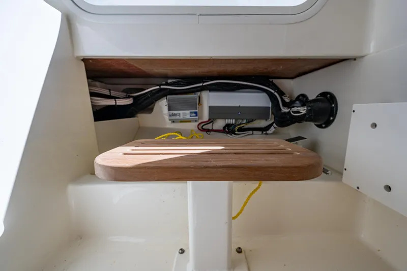 Slide: The Image of Interior view of 2023 Boston Whaler 330 Outrage boat, showcasing storage and wiring. - 49